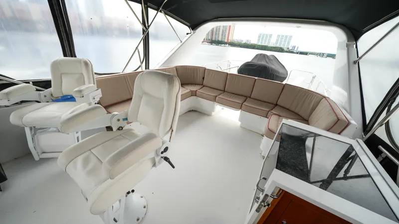 Slide: The Image of Interior of 2002 Queenship 70 Baretta yacht with white seating and panoramic windows. - 27