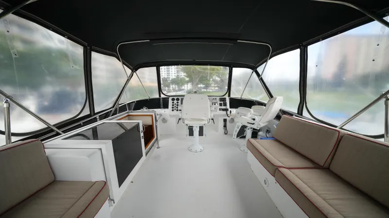 Slide: The Image of Interior of 2002 Queenship 70 Baretta yacht with seating and helm station. - 28