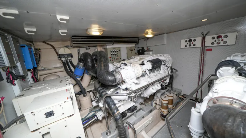 Slide: The Image of Engine room of a 2002 Queenship 70 Baretta yacht with visible machinery and equipment. - 29