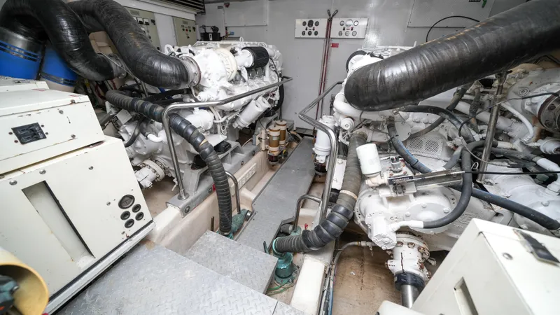 Slide: The Image of Engine room of a 2002 Queenship 70 Baretta yacht with dual engines and control panels. - 30