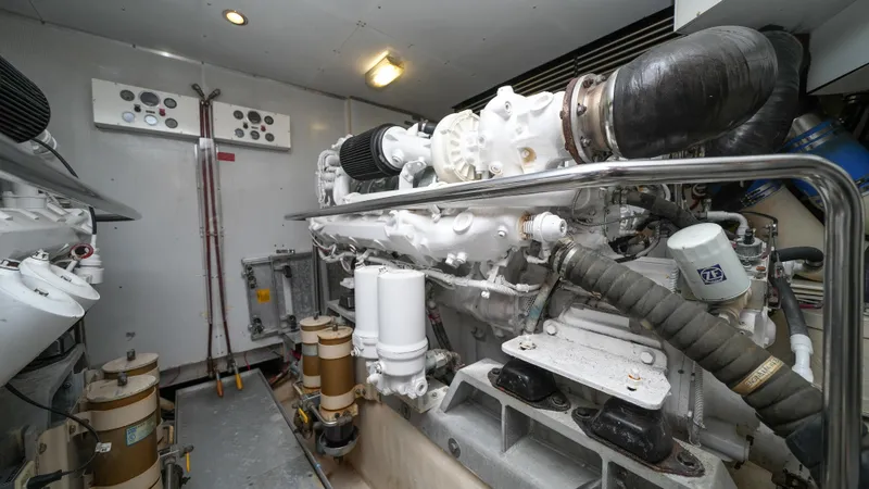 Slide: The Image of Engine room of a 2002 Queenship 70 Baretta yacht with visible machinery. - 31