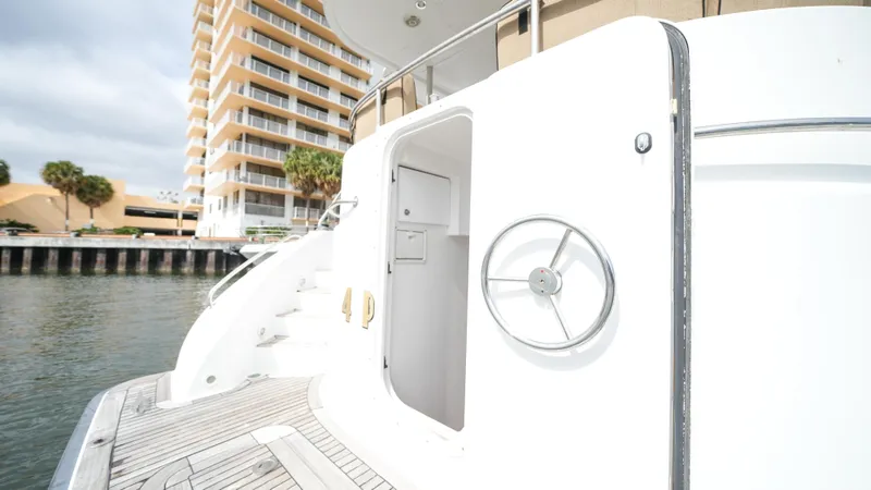 Slide: The Image of 2002 Queenship 70 Baretta yacht docked near waterfront buildings. - 35