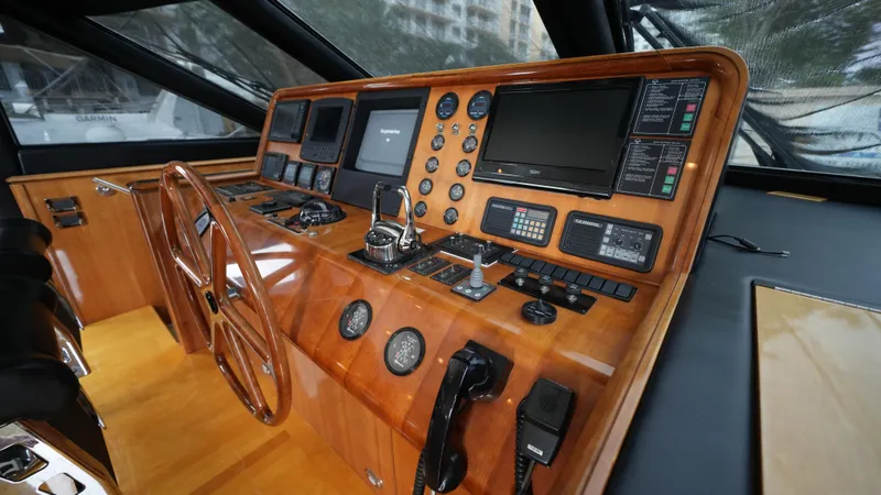 Slide: The Image of Helm station of 2002 Queenship 70 Baretta yacht with wooden dashboard and modern navigation equipment. - 4