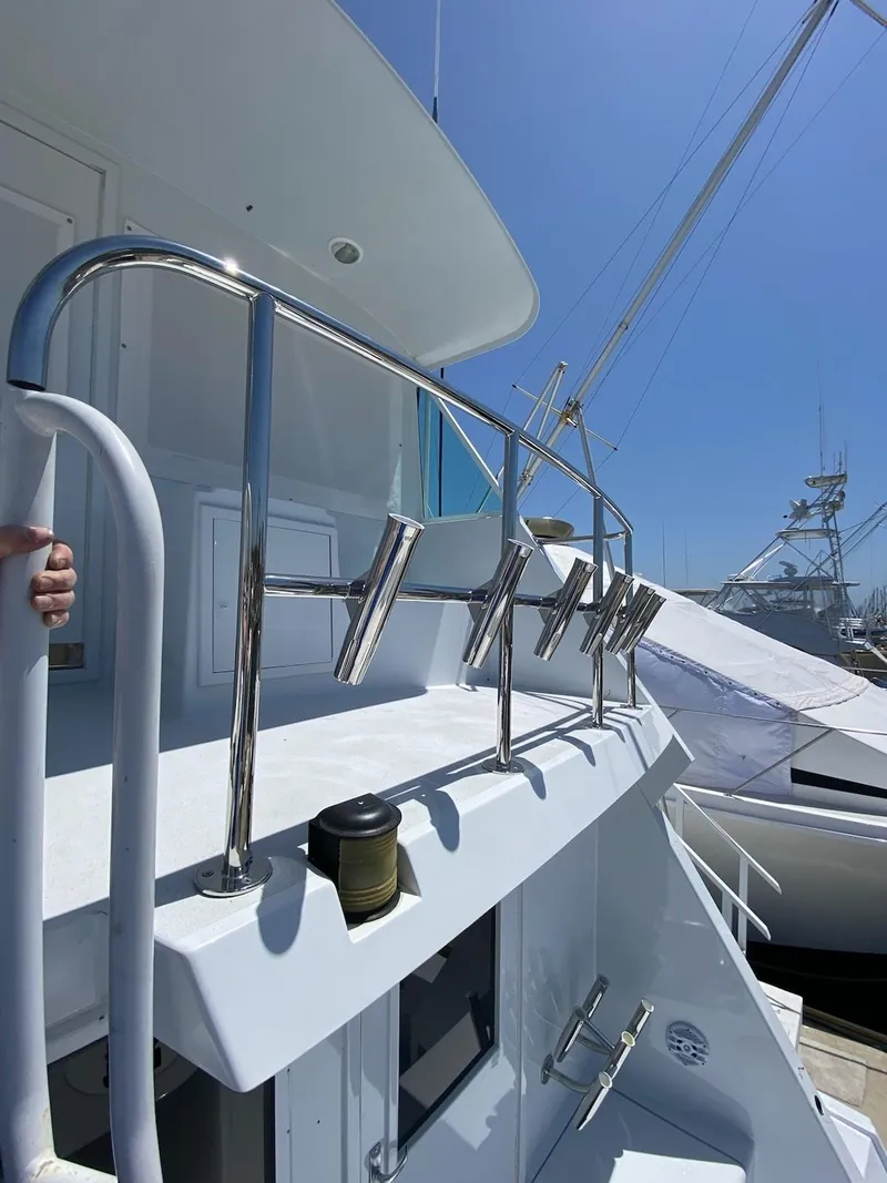 Slide: The Image of 1988 Hatteras 65 Convertible yacht deck with rod holders. - 28