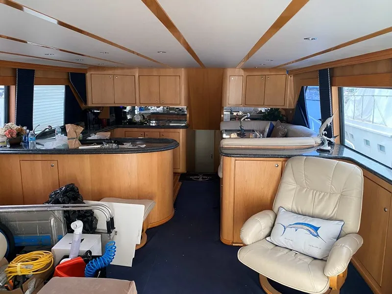 Slide: The Image of Interior of 1988 Hatteras 65 Convertible yacht with wooden cabinetry and plush seating. - 8