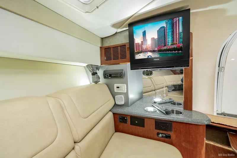Slide: The Image of Interior of 2008 Formula 310 Sun Sport with TV, beige seating, and control panel. - 14