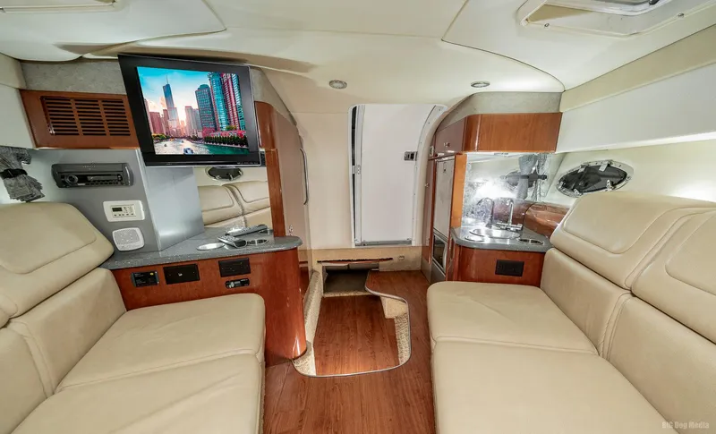 Slide: The Image of Interior of 2008 Formula 310 Sun Sport boat with beige seating and mounted TV. - 16