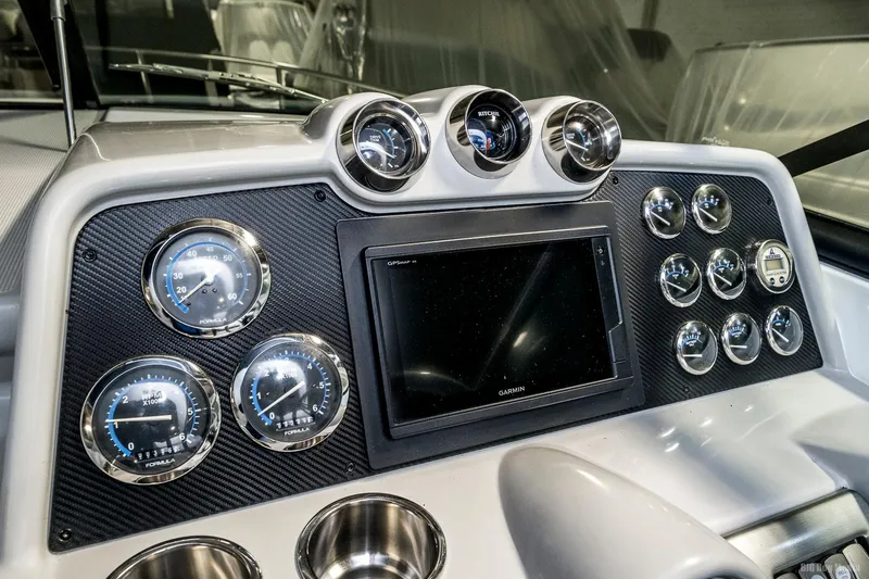 Slide: The Image of Dashboard of a 2008 Formula 310 Sun Sport boat with gauges and Garmin display. - 25
