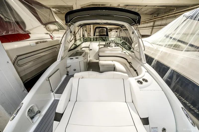 Slide: The Image of 2008 Formula 310 Sun Sport boat interior with white seating and helm station. - 29