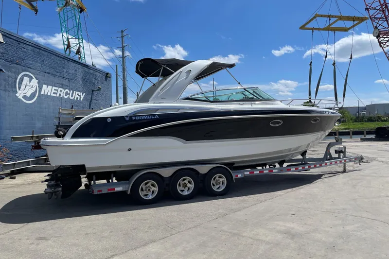 Slide: The Image of 2008 Formula 310 Sun Sport boat on a trailer at a marina. - 4