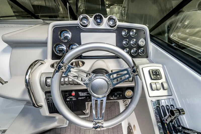 Slide: The Image of 2008 Formula 310 Sun Sport boat dashboard with steering wheel and control panel. - 9