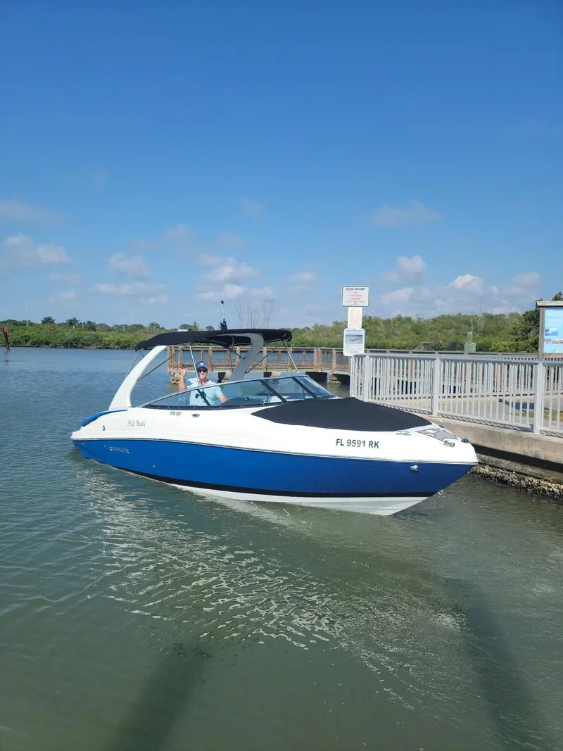 Slide: The Image of 2018 Rinker QX 26 boat docked on a sunny day. - 0