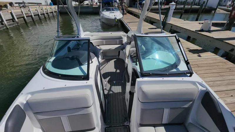 Slide: The Image of 2018 Rinker QX 26 boat docked at a marina, interior view. - 17