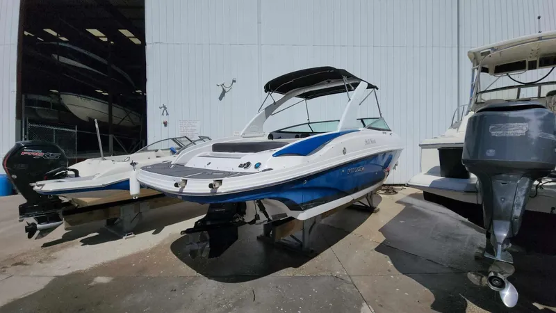 Slide: The Image of 2018 Rinker QX 26 boat docked at a marina, ready for use. - 18