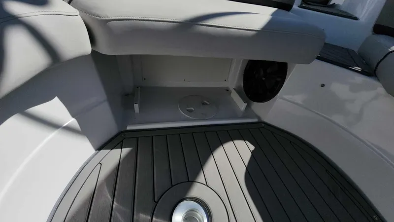 Slide: The Image of 2018 Rinker QX 26 boat interior with gray seating and flooring. - 20