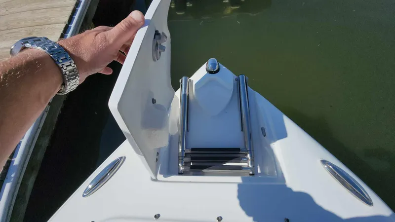 Slide: The Image of 2018 Rinker QX 26 boat bow with anchor storage compartment open. - 25