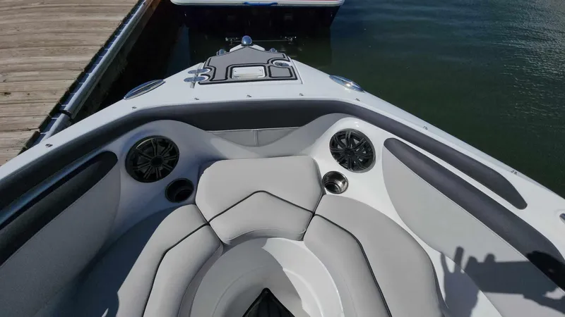 Slide: The Image of 2018 Rinker QX 26 boat bow seating area with speakers and cup holders. - 26