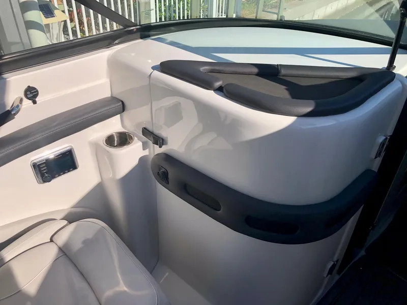 Slide: The Image of 2018 Rinker QX 26 boat interior with seating and control panel. - 3