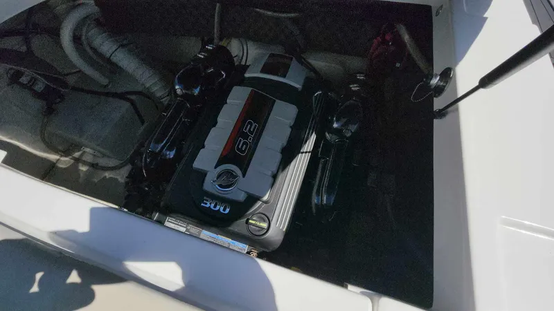Slide: The Image of 2018 Rinker QX 26 boat engine compartment with MerCruiser 6.2L 300 HP engine. - 31