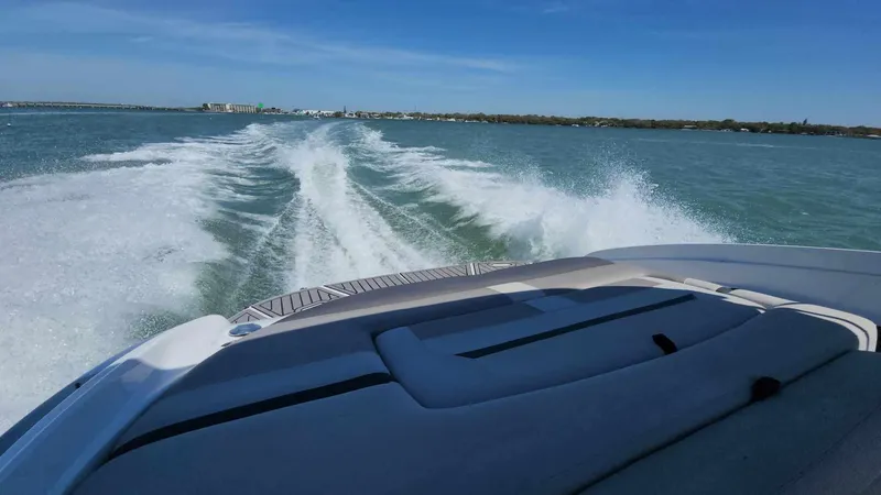 Slide: The Image of 2018 Rinker QX 26 boat cruising on open water. - 33