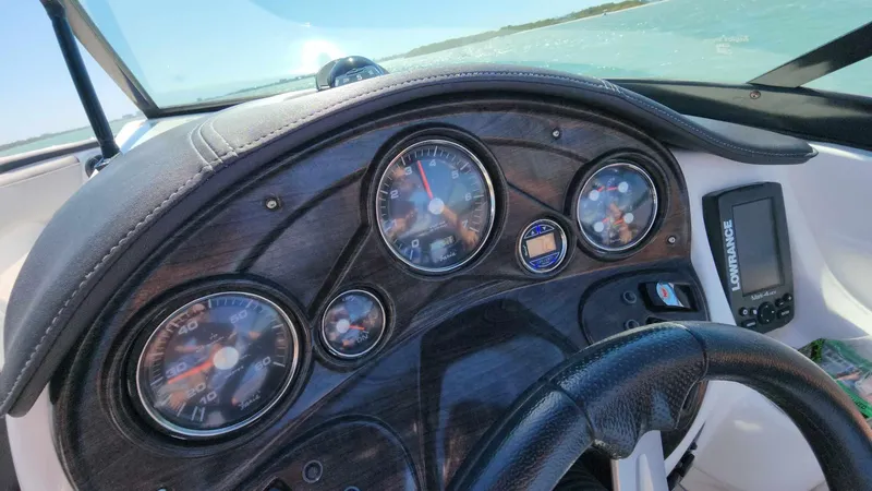 Slide: The Image of 2018 Rinker QX 26 boat dashboard with gauges and navigation system. - 34