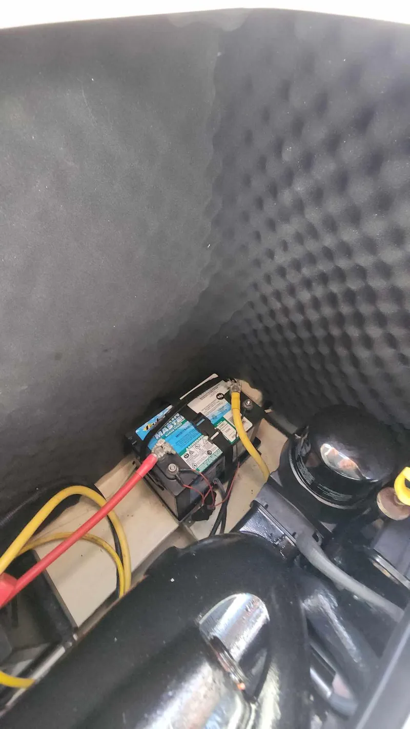 Slide: The Image of 2018 Rinker QX 26 boat engine compartment with wiring and components. - 35