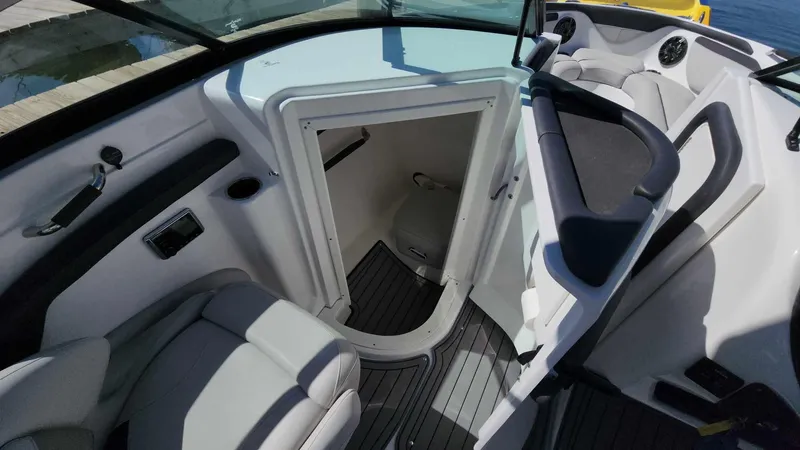 Slide: The Image of 2018 Rinker QX 26 boat interior with open cabin door and seating. - 46