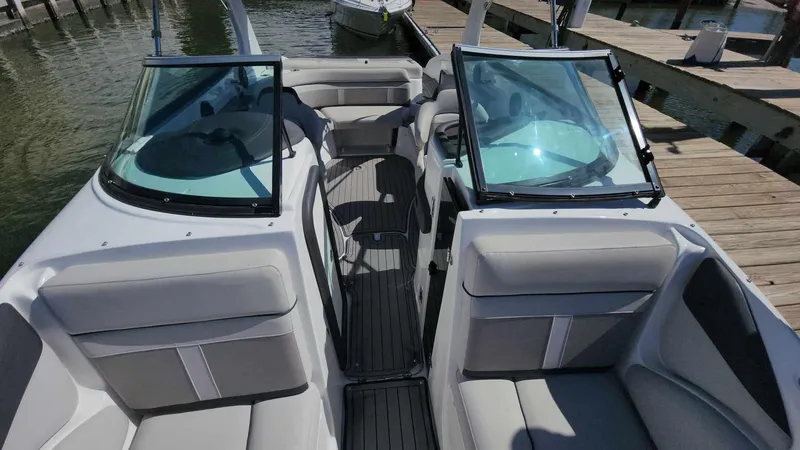 Slide: The Image of 2018 Rinker QX 26 boat interior with seating and open windshield. - 48
