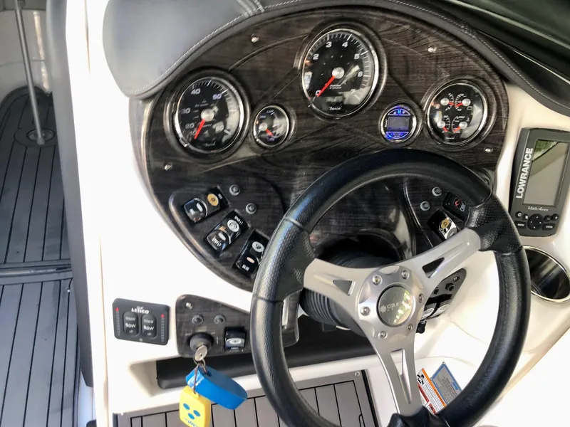 Slide: The Image of 2018 Rinker QX 26 boat dashboard with steering wheel and instrument panel. - 6