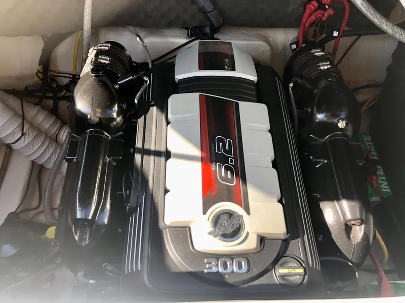 Slide: The Image of 2018 Rinker QX 26 boat engine compartment with 6.2L 300 HP MerCruiser engine. - 7
