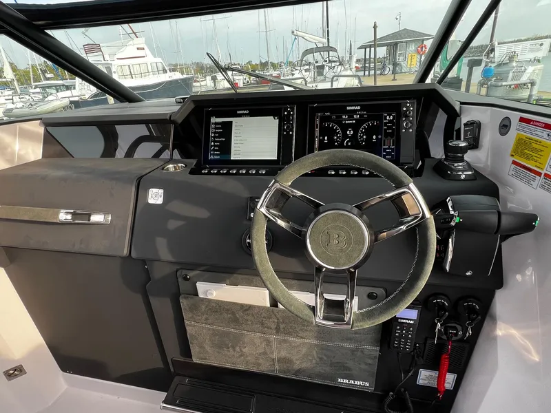 Slide: The Image of 2024 Axopar 37 Sun Top Mediterrana Edition helm with modern controls and navigation displays. - 17