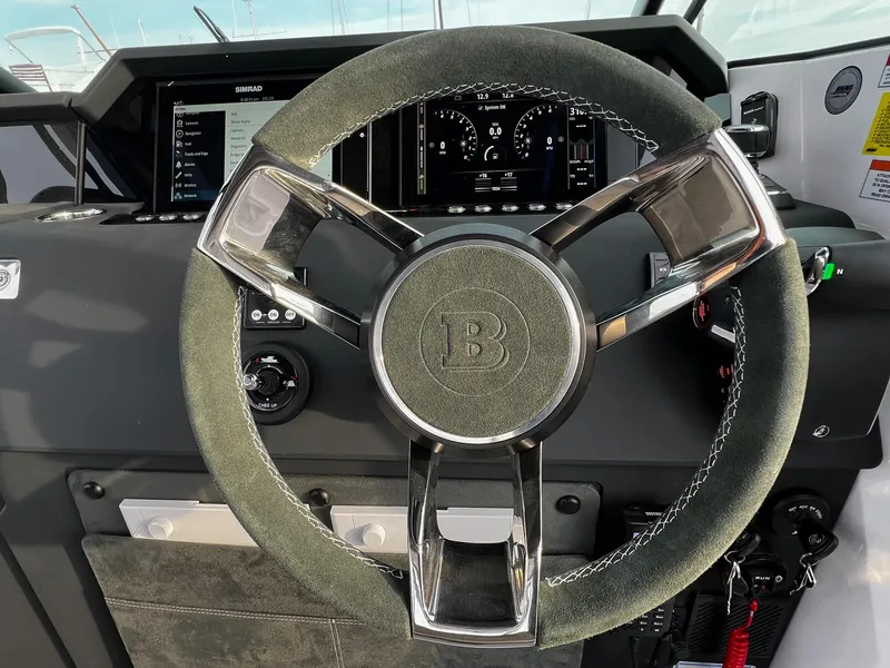Slide: The Image of Steering wheel of 2024 Axopar 37 Sun Top Mediterrana Edition, featuring modern dashboard controls. - 18