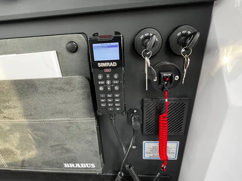 Slide: The Image of Control panel of 2024 Axopar 37 Sun Top Mediterrana Edition with Simrad device and ignition keys. - 20