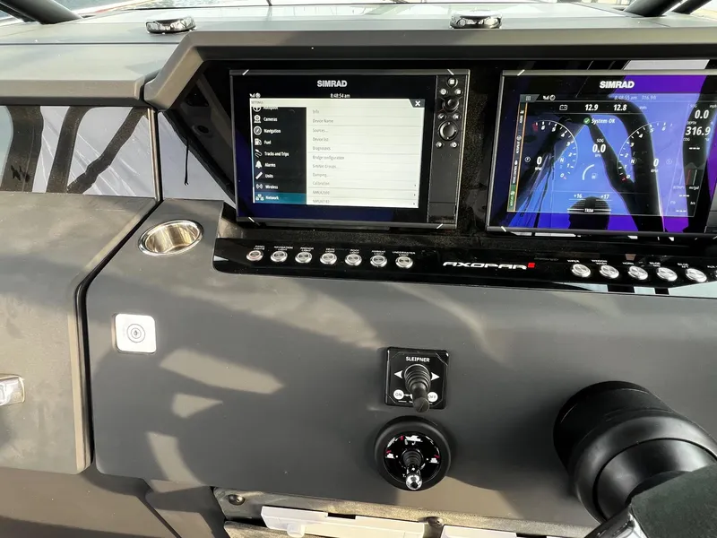 Slide: The Image of 2024 Axopar 37 Sun Top Mediterrana Edition dashboard with Simrad navigation displays. - 21
