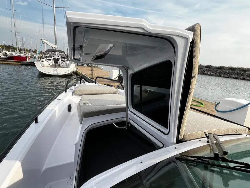 Slide: The Image of 2024 Axopar 37 Sun Top Mediterrana Edition docked, showcasing sleek design and spacious seating. - 24