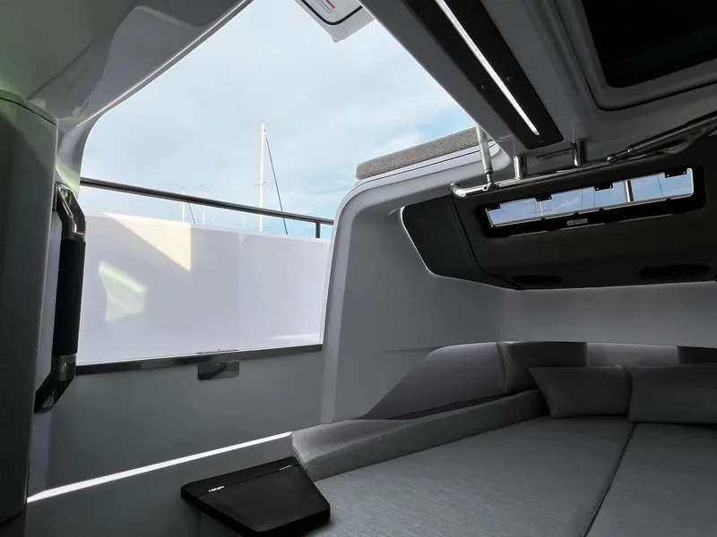 Slide: The Image of 2024 Axopar 37 Sun Top Mediterrana Edition cabin interior with modern design and skylight. - 25