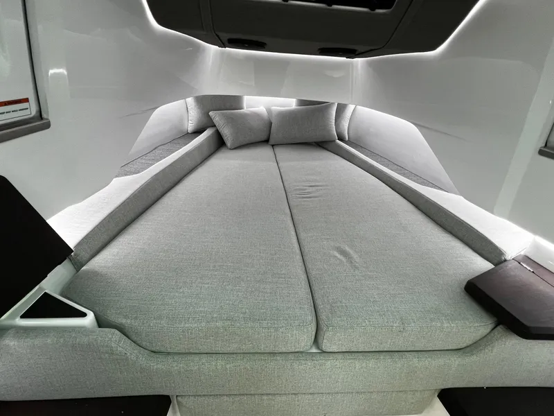 Slide: The Image of 2024 Axopar 37 Sun Top Mediterrana Edition interior with sleek, modern bedding and cushions. - 27
