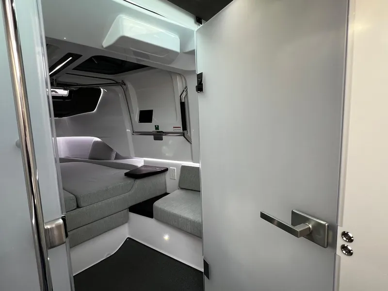 Slide: The Image of 2024 Axopar 37 Sun Top Mediterrana Edition cabin interior with modern design and seating. - 29