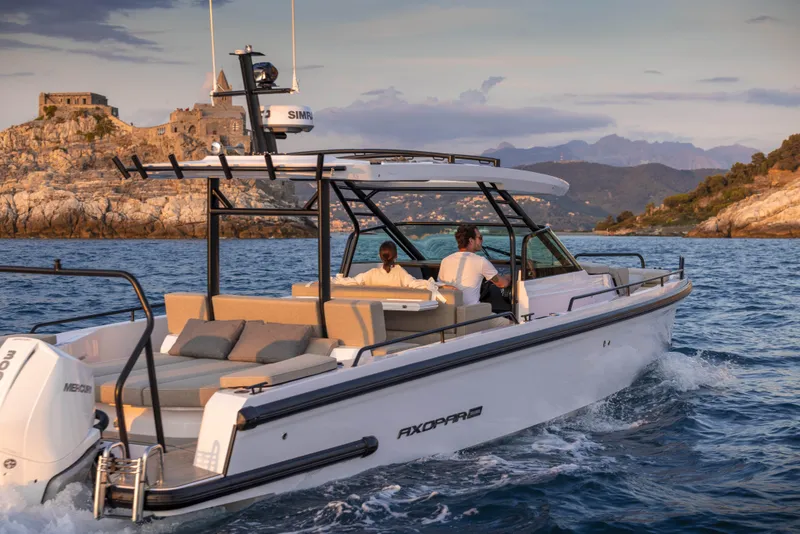 Slide: The Image of 2024 Axopar 37 Sun Top Mediterrana Edition cruising near rocky coastline. - 34