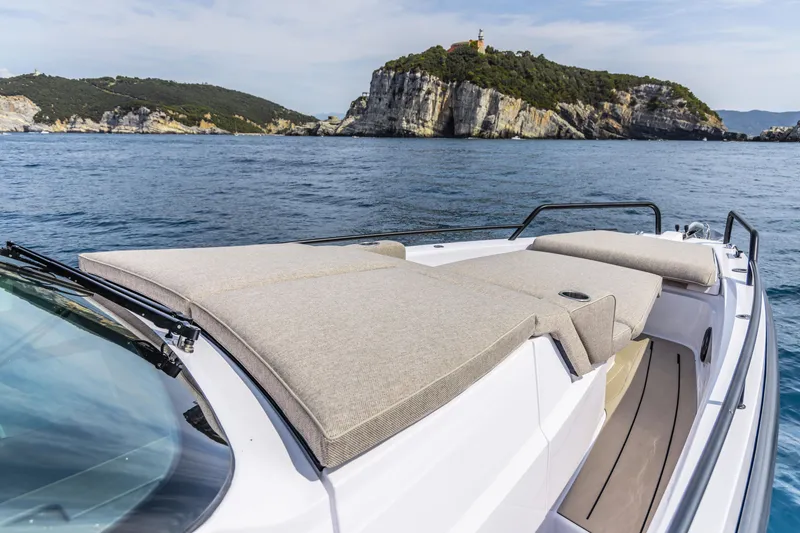 Slide: The Image of 2024 Axopar 37 Sun Top Mediterrana Edition luxury boat with scenic coastal backdrop. - 36