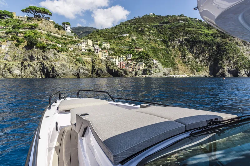 Slide: The Image of 2024 Axopar 37 Sun Top Mediterrana Edition cruising near scenic coastal cliffs. - 38