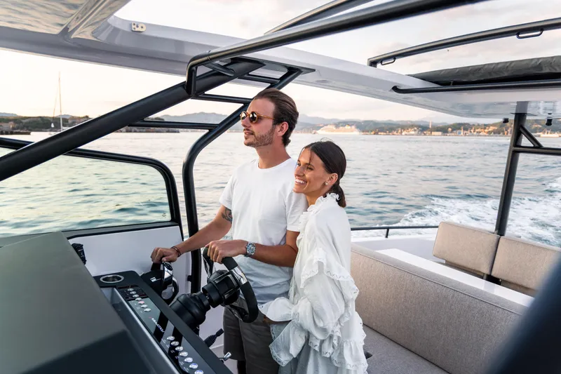 Slide: The Image of Couple enjoying a ride on a 2024 Axopar 37 Sun Top Mediterrana Edition boat. - 41