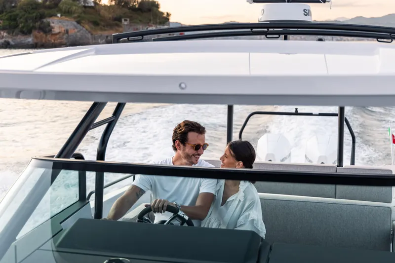 Slide: The Image of Couple enjoying a ride on the 2024 Axopar 37 Sun Top Mediterrana Edition boat. - 42