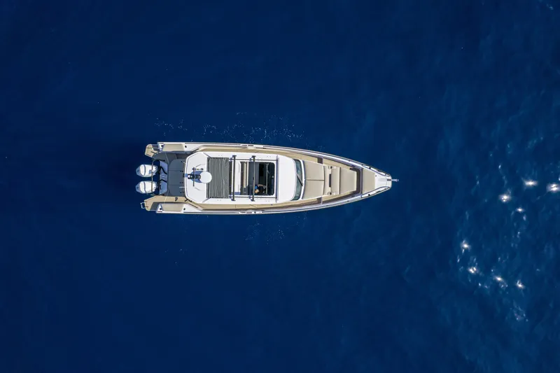 Slide: The Image of Aerial view of 2024 Axopar 37 Sun Top Mediterrana Edition on blue water. - 49