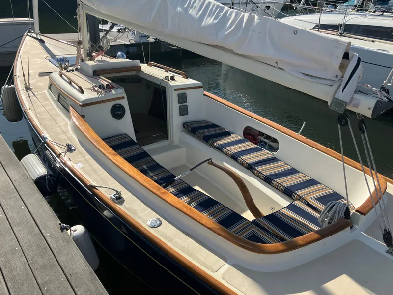 Slide: The Image of 2012 Morris M29 sailboat with striped cushions docked at marina. - 10