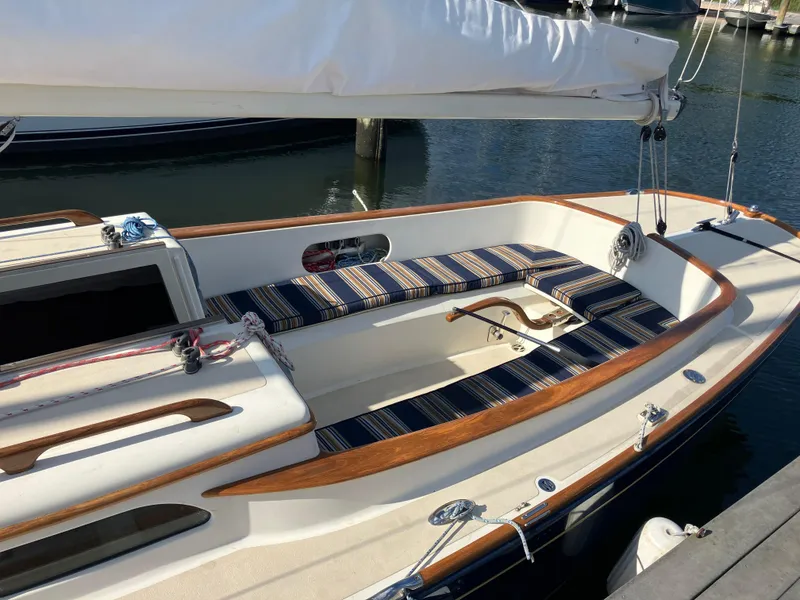 Slide: The Image of Morris M29 2012 sailboat with striped seating, docked in a marina. - 2