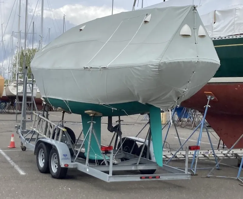 Slide: The Image of Covered Morris M29 sailboat on trailer, 2012 model, in a marina storage area. - 5