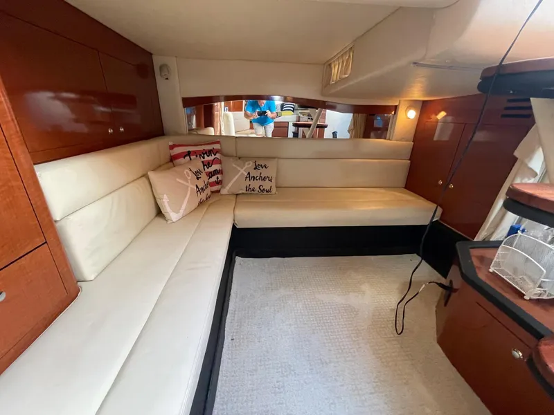 Slide: The Image of Interior of 2007 Sea Ray 340 Sundancer with white leather seating and decorative pillows. - 4