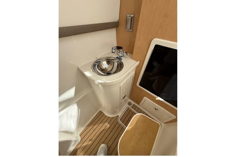 Slide: The Image of 2026 World Cat 325 DC boat interior with sink and wooden flooring. - 10