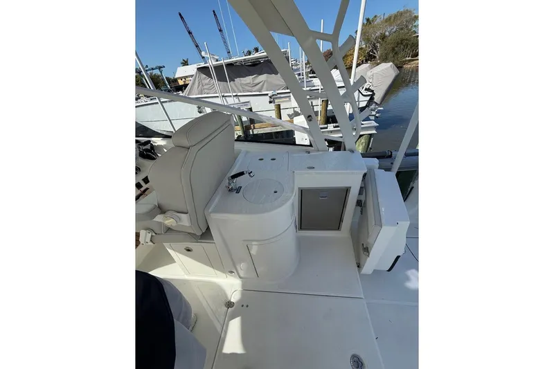 Slide: The Image of 2026 World Cat 325 DC boat interior with seating and storage at a marina. - 12